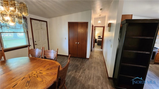 2384 State Route 109, Delta, OH 43515 - dining area featuring a chandelier, wood finished floors, and lofted ceiling