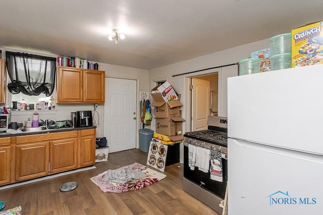 2721 Fremont St, Toledo, OH 43605 - kitchen with appliances with stainless steel finishes, dark wood-style flooring, a sink, and dark countertops
