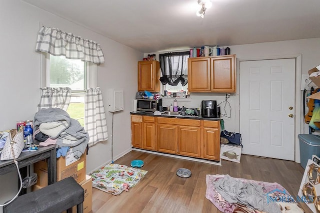 2721 Fremont St, Toledo, OH 43605 - kitchen with dark wood-style floors, stainless steel microwave, dark countertops, brown cabinets, and a sink