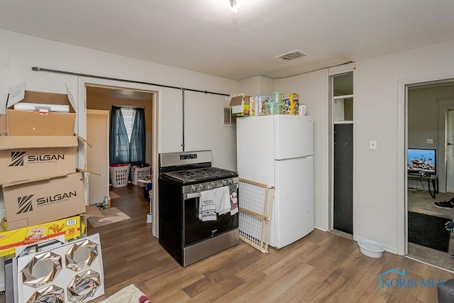 2721 Fremont St, Toledo, OH 43605 - kitchen featuring stainless steel range with gas cooktop, freestanding refrigerator, and wood finished floors