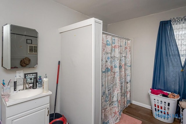2721 Fremont St, Toledo, OH 43605 - bathroom featuring vanity, wood finished floors, curtained shower, and baseboards