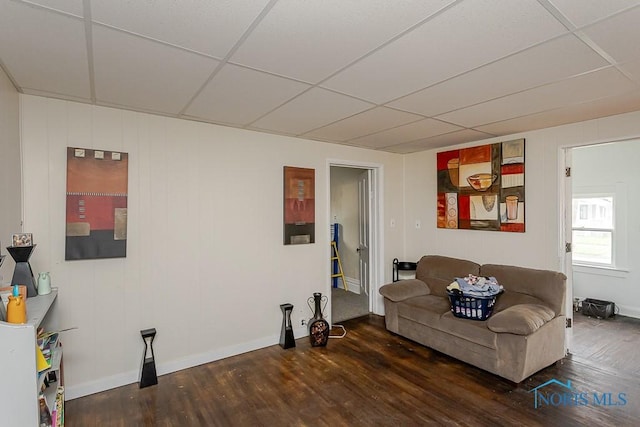 635 Plymouth St, Toledo, OH 43605 - living area with wood finished floors, a paneled ceiling, and baseboards