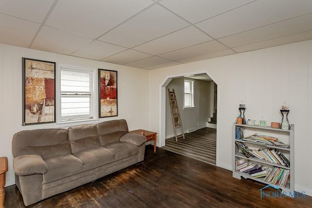 635 Plymouth St, Toledo, OH 43605 - living room with arched walkways, a paneled ceiling, wood finished floors, stairway, and baseboards