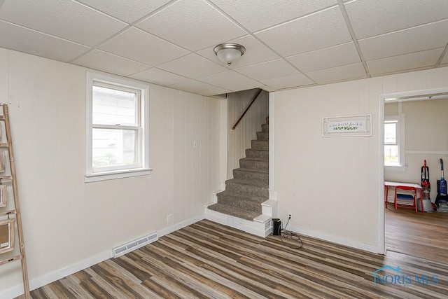 635 Plymouth St, Toledo, OH 43605 - below grade area featuring dark wood-style flooring, stairway, baseboards, and a drop ceiling