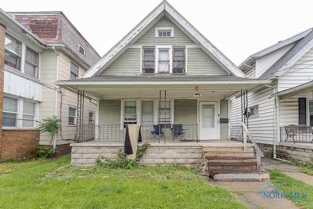 1215 Starr Ave, Toledo, OH 43605 - view of front of house featuring a porch and a front lawn
