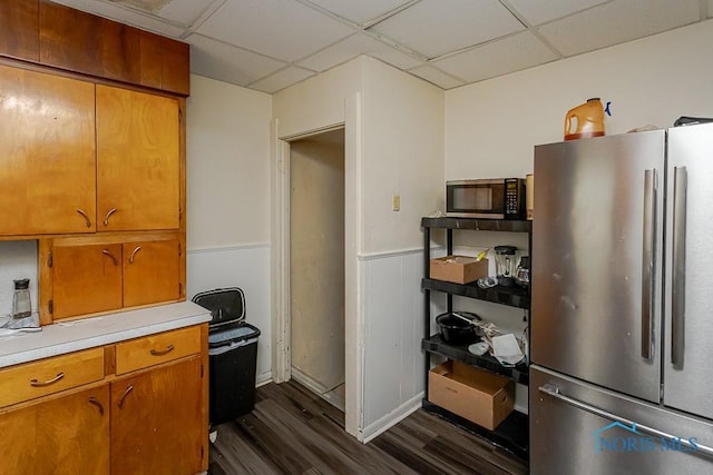 1215 Starr Ave, Toledo, OH 43605 - kitchen featuring stainless steel appliances, dark wood-style flooring, a paneled ceiling, light countertops, and brown cabinetry