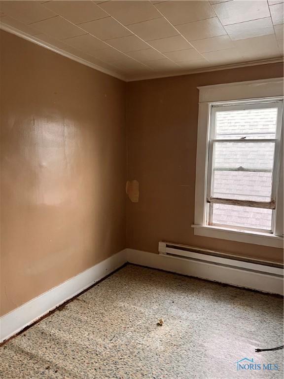 527 E Weber, Toledo, OH 43608 - unfurnished room with a baseboard radiator, ornamental molding, and baseboards