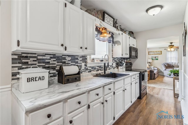 8399 W State Route 12, Fostoria, OH 44830 - kitchen featuring black appliances, a sink, a ceiling fan, dark wood finished floors, and white cabinets
