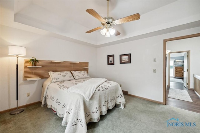 2543 Broadway St Unit 2543, Toledo, OH 43609 - bedroom featuring baseboards, carpet floors, a raised ceiling, and ceiling fan