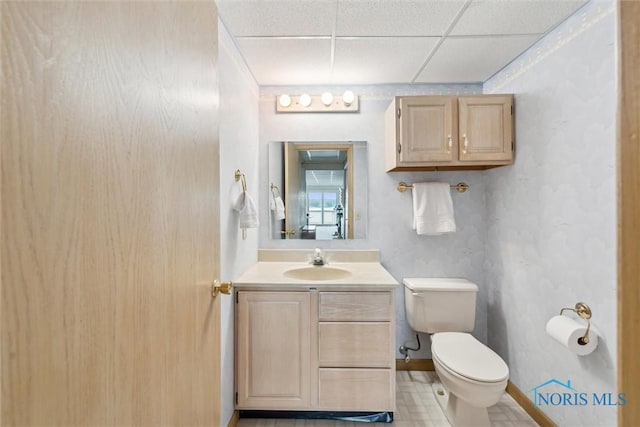 2543 Broadway St Unit 2543, Toledo, OH 43609 - half bathroom with a drop ceiling, toilet, vanity, and baseboards