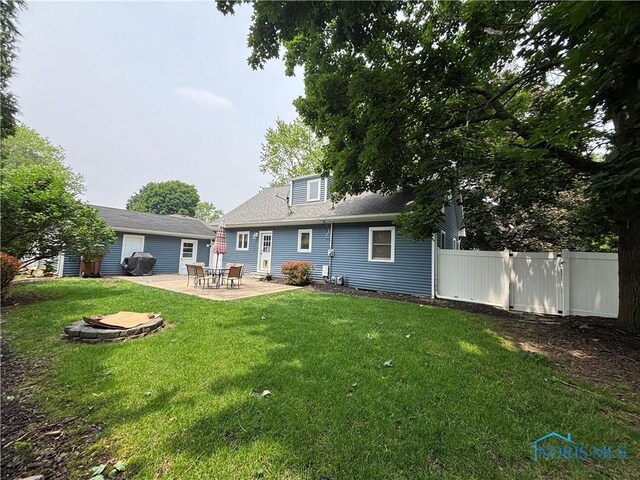 803 W Holland St, Archbold, OH 43502 - rear view of property featuring a patio and an outdoor fire pit