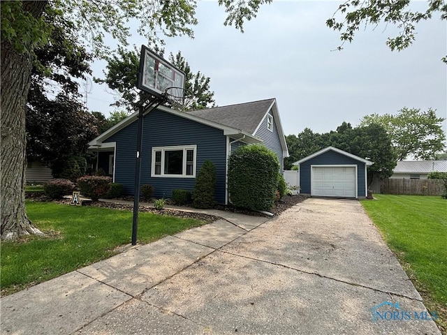 803 W Holland St, Archbold, OH 43502 - view of front facade featuring concrete driveway, an outbuilding, and a garage