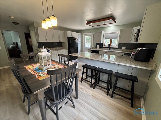 803 W Holland St, Archbold, OH 43502 - dining space featuring light wood-style flooring