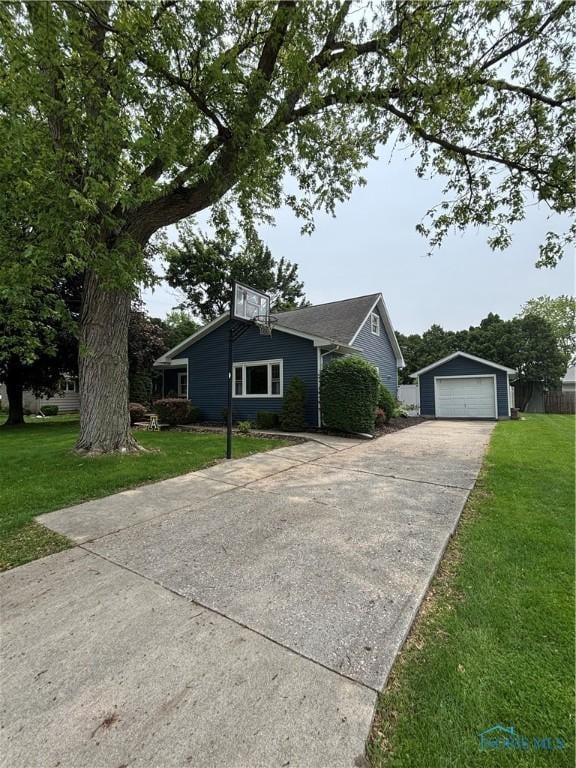 803 W Holland St, Archbold, OH 43502 - view of front facade with a detached garage, an outbuilding, concrete driveway, and a front lawn