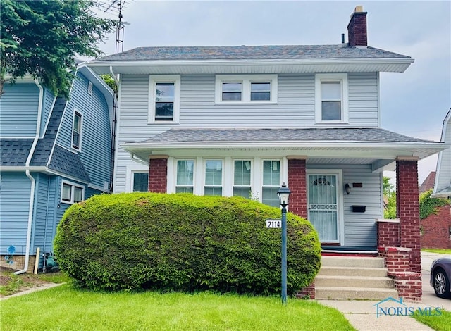 2114 Parkdale Ave, Toledo, OH 43607 - view of front facade featuring a chimney, a shingled roof, and brick siding