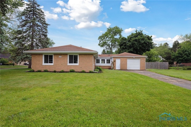 1240 Westgate Rd, Toledo, OH 43615 - ranch-style home featuring asphalt driveway, brick siding, and a garage