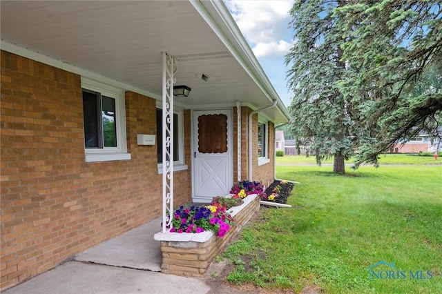 1240 Westgate Rd, Toledo, OH 43615 - property entrance featuring a yard and brick siding
