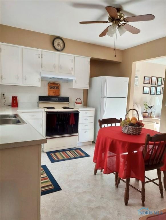 308 Jackson St, Delta, OH 43515 - kitchen with range with electric cooktop, freestanding refrigerator, under cabinet range hood, light countertops, and light floors