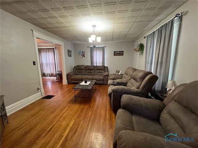 430 W Johnson St, Upper Sandusky, OH 43351 - living room with a chandelier, wood finished floors, an ornate ceiling, and baseboards