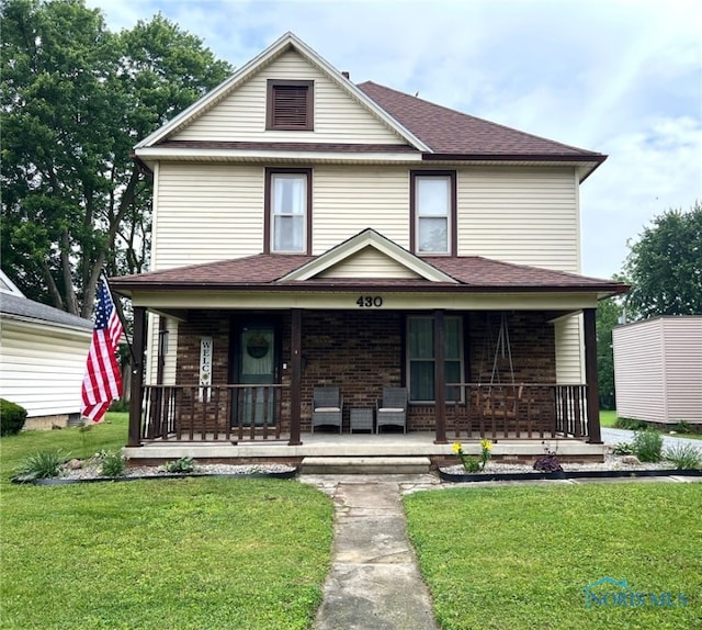 430 W Johnson St, Upper Sandusky, OH 43351 - american foursquare style home featuring a porch and a front yard