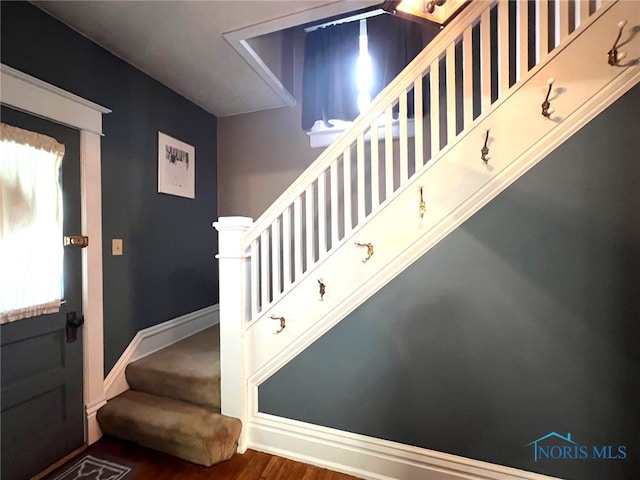430 W Johnson St, Upper Sandusky, OH 43351 - foyer entrance featuring stairs, wood finished floors, and baseboards