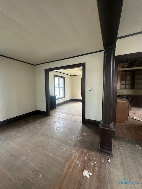 831 Oak St, Toledo, OH 43605 - empty room featuring hardwood / wood-style flooring, baseboards, and ornate columns