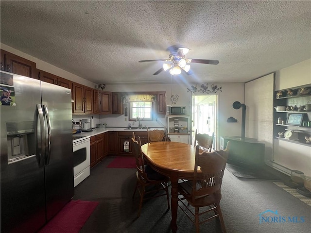 2546 State Route 66, Cloverdale, OH 45827 - kitchen with appliances with stainless steel finishes, ceiling fan, a sink, a textured ceiling, and light countertops
