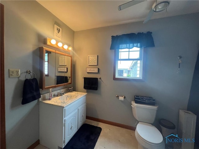 2546 State Route 66, Cloverdale, OH 45827 - bathroom with toilet, vanity, baseboards, and a ceiling fan
