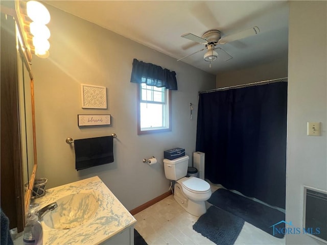 2546 State Route 66, Cloverdale, OH 45827 - bathroom with vanity, toilet, ceiling fan, curtained shower, and baseboards