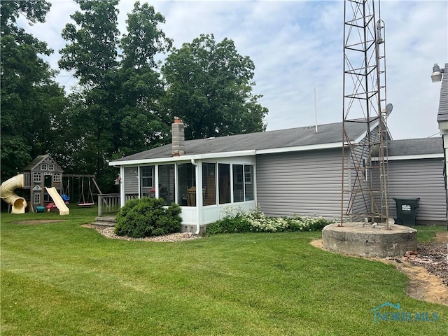2546 State Route 66, Cloverdale, OH 45827 - back of house with a playground, a lawn, a sunroom, and a chimney