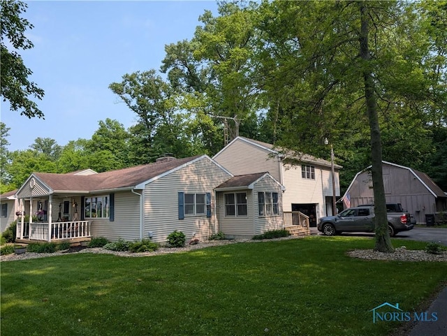 7194 County Road 86, Findlay, OH 45840 - view of front facade featuring an attached garage, covered porch, a front yard, and roof with shingles