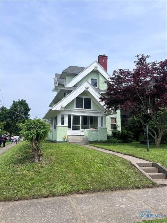 2740 Robinwood Ave, Toledo, OH 43610 - view of front of house with a front lawn and a chimney