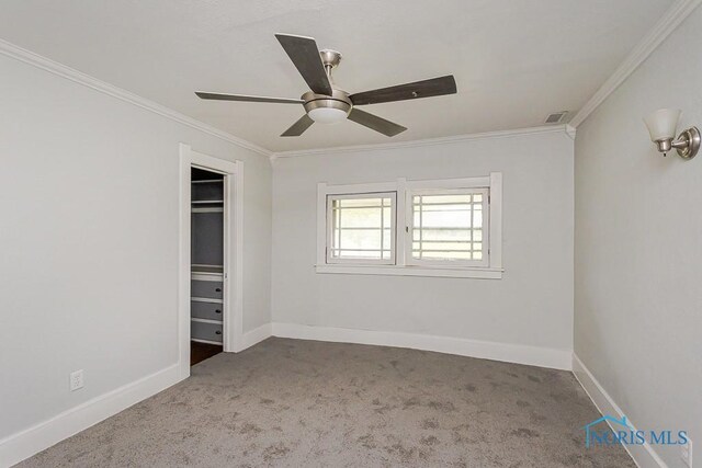 2740 Robinwood Ave, Toledo, OH 43610 - unfurnished bedroom featuring crown molding, carpet flooring, a ceiling fan, and a closet