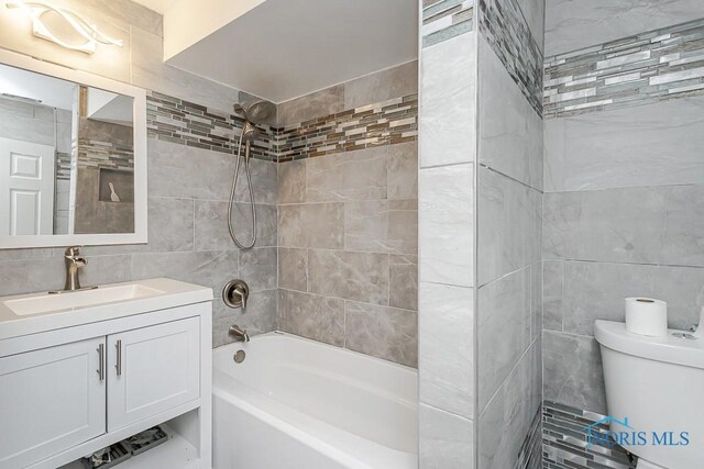 2740 Robinwood Ave, Toledo, OH 43610 - full bathroom featuring tile walls, shower / bathtub combination, and vanity
