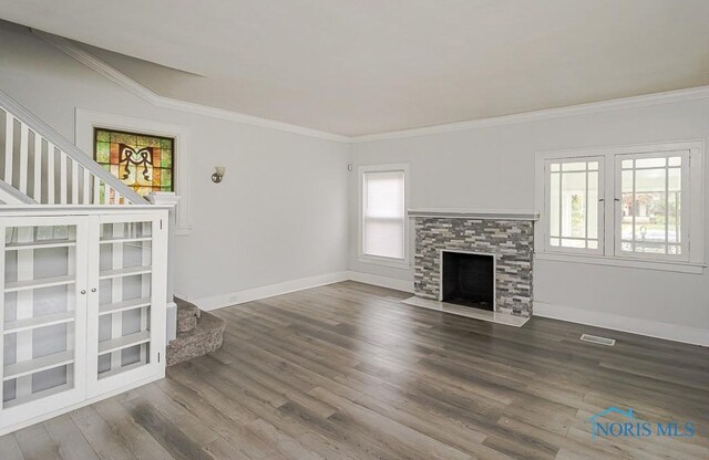 2740 Robinwood Ave, Toledo, OH 43610 - unfurnished living room with stairs, ornamental molding, wood finished floors, and a fireplace