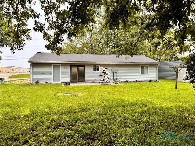 1019 E Wilson St, Bryan, OH 43506 - rear view of property featuring a patio area and a lawn