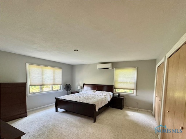 534 S Butternut St, Deshler, OH 43516 - bedroom featuring a wall mounted air conditioner, light colored carpet, and multiple closets