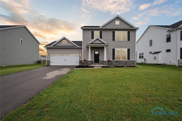 8805 Birchfield Rd, Sylvania, OH 43560 - traditional home with stone siding, driveway, a front lawn, and an attached garage
