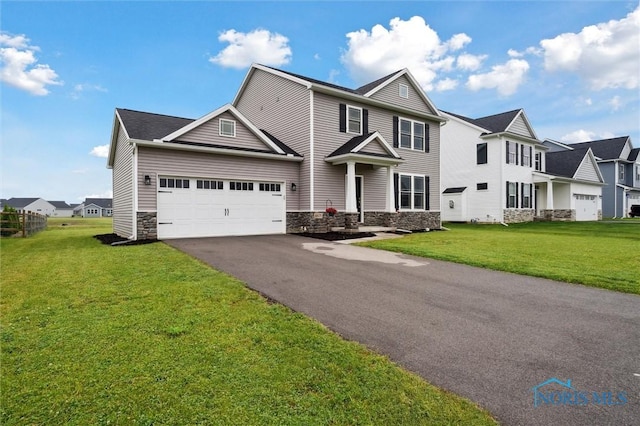 8805 Birchfield Rd, Sylvania, OH 43560 - view of front of home with stone siding, a garage, asphalt driveway, and a front yard