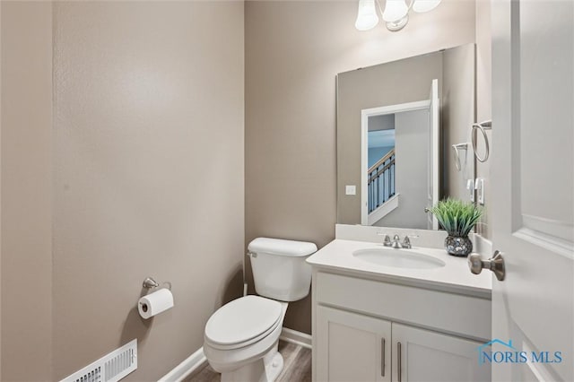 8805 Birchfield Rd, Sylvania, OH 43560 - half bath featuring toilet, vanity, baseboards, and wood finished floors