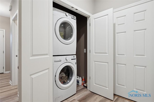 8805 Birchfield Rd, Sylvania, OH 43560 - laundry area featuring stacked washing machine and dryer and light wood finished floors