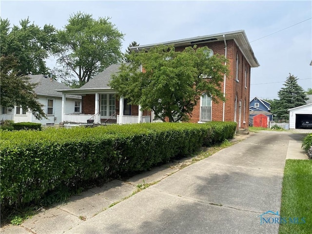 232 N Franklin St, Wauseon, OH 43567 - view of front of property featuring brick siding and an outbuilding