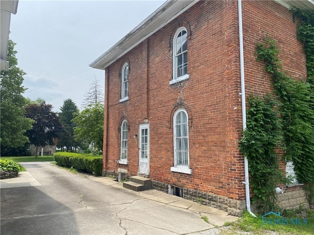 232 N Franklin St, Wauseon, OH 43567 - view of home's exterior featuring brick siding and entry steps