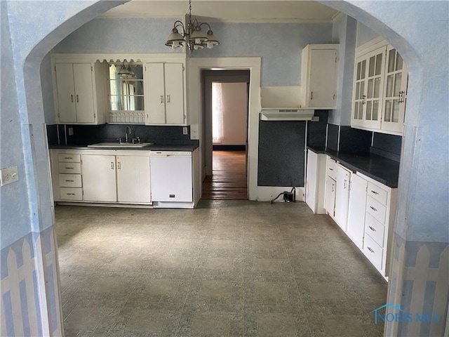 232 N Franklin St, Wauseon, OH 43567 - kitchen with a sink, white dishwasher, under cabinet range hood, dark countertops, and decorative backsplash