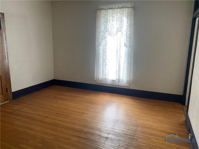 232 N Franklin St, Wauseon, OH 43567 - empty room with wood finished floors and baseboards