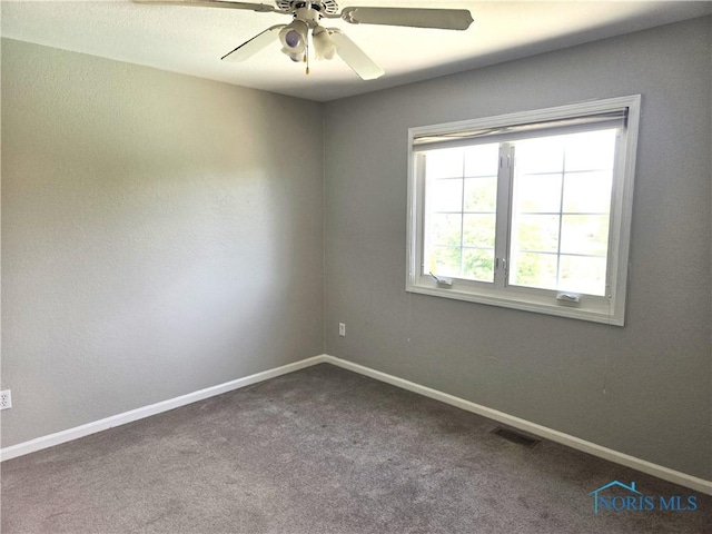 4811 Cabriolet Ln, Maumee, OH 43537 - empty room with dark colored carpet and ceiling fan