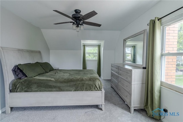 2834 123rd St, Toledo, OH 43611 - bedroom featuring light colored carpet, multiple windows, vaulted ceiling, and ceiling fan