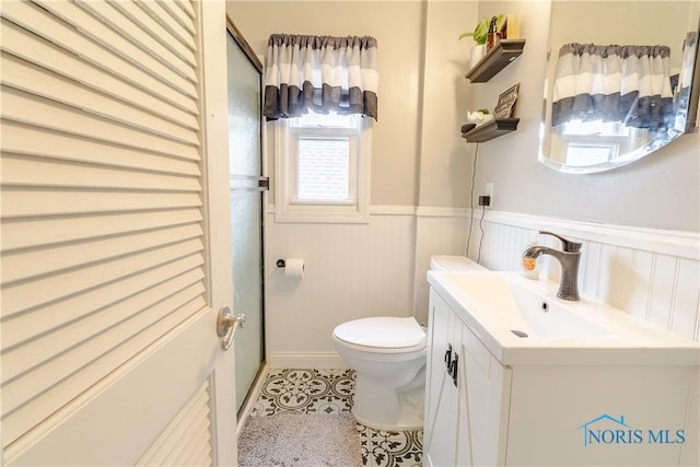 2834 123rd St, Toledo, OH 43611 - bathroom featuring vanity, toilet, and wainscoting