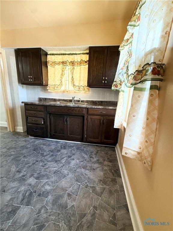 5455 Douglas Rd, Toledo, OH 43613 - kitchen featuring dark brown cabinets and dark stone finish flooring