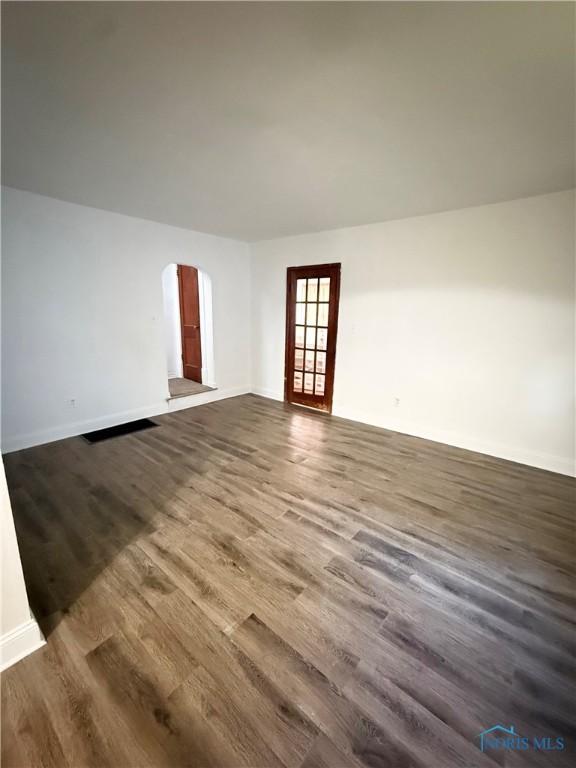 5455 Douglas Rd, Toledo, OH 43613 - spare room with arched walkways and dark wood-style floors